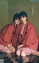 A couple of women sitting next to each other on a table.