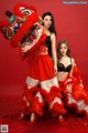 A couple of women dressed in red and white posing for a picture.