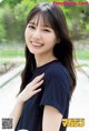 A woman in a black shirt is posing for a picture.