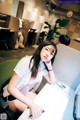 A woman sitting at a desk in front of a computer.